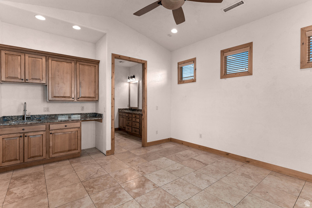 2464 East Granite Way St. George, UT 84790 - Photo 85 of 106 Guest suite with kitchenette, lofted ceiling, ceiling fan, recessed lighting, dark stone countertops, and arched walkways