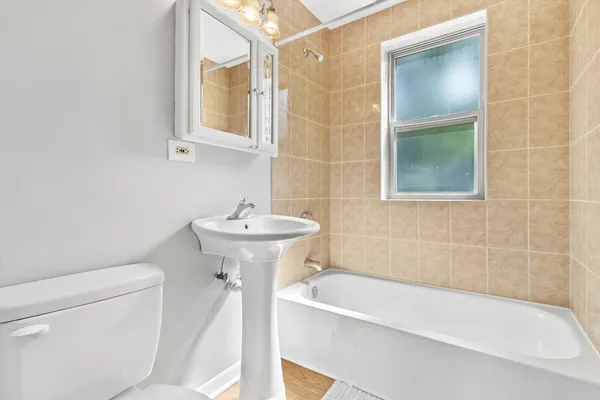 a white bath tub sitting next to a white sink