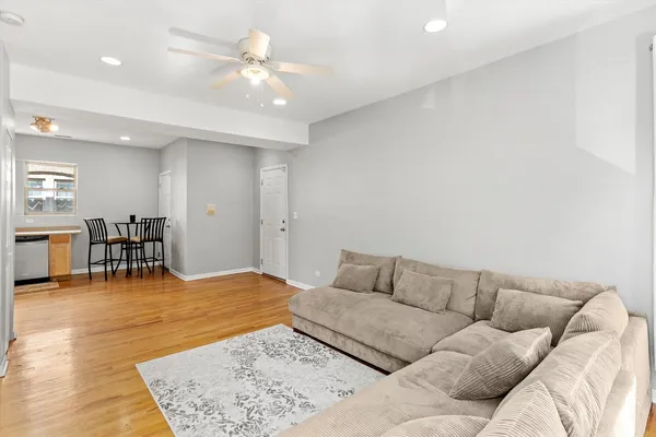 a living room with furniture and kitchen view