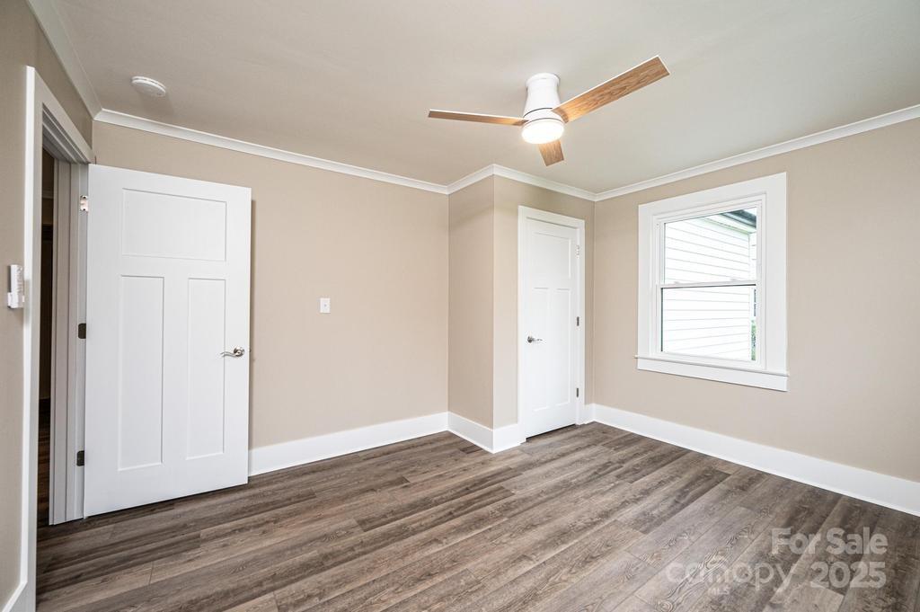 1105 Wildwood Road Lenoir, NC 28645 - Photo 19 of 38 a view of an empty room with wooden floor and a window