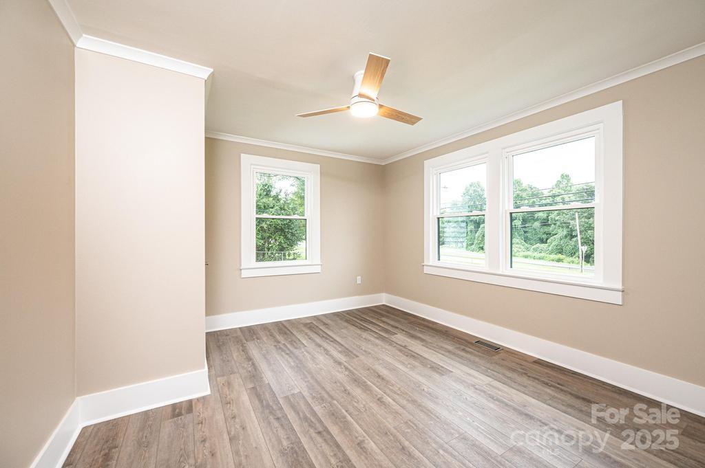 1105 Wildwood Road Lenoir, NC 28645 - Photo 20 of 38 a view of an empty room with wooden floor and a window