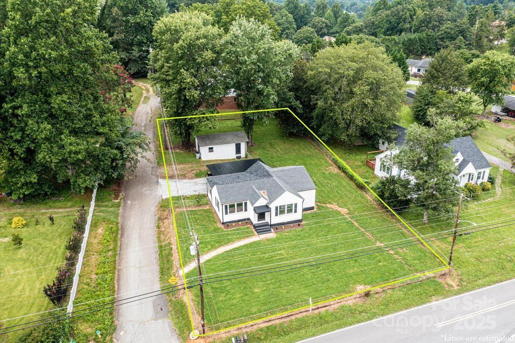 1105 Wildwood Road Lenoir, NC 28645 - Photo 2 of 38 a backyard of a house with table and chairs