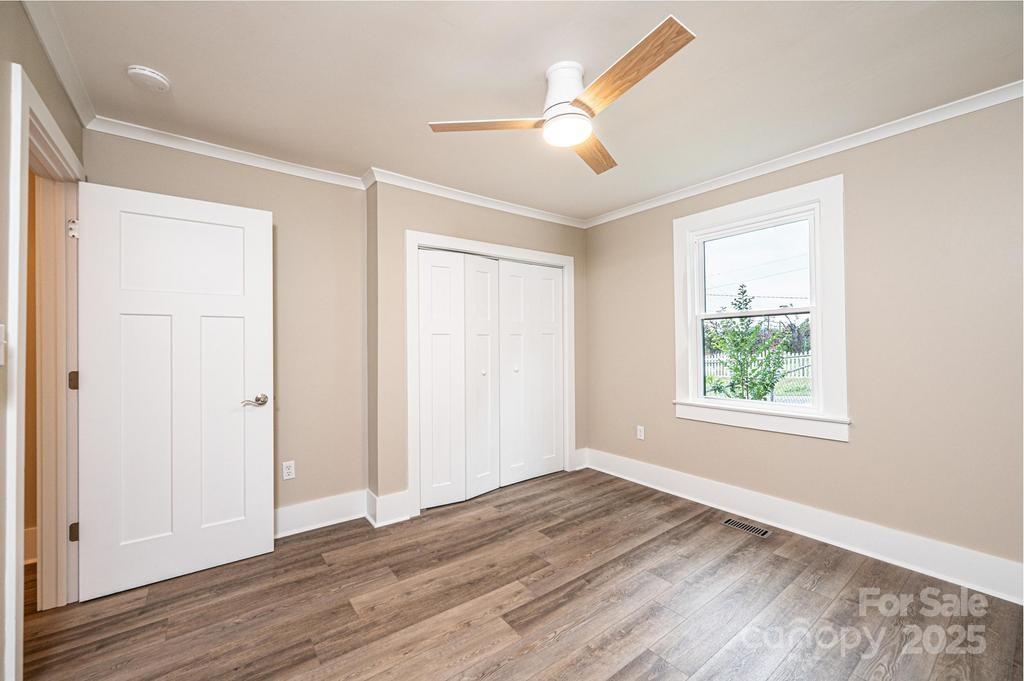 1105 Wildwood Road Lenoir, NC 28645 - Photo 22 of 38 a view of an empty room with wooden floor and a window