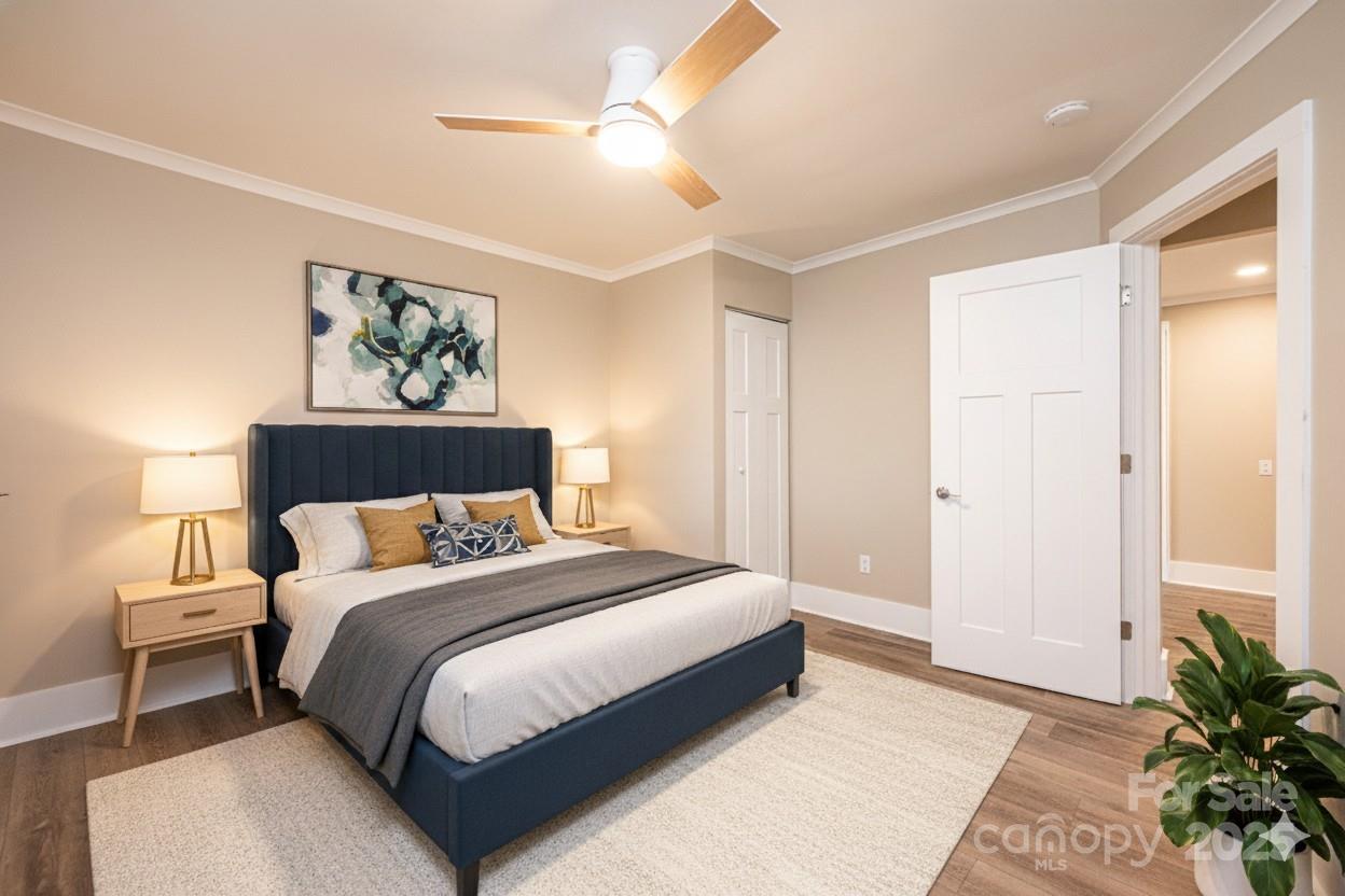 1105 Wildwood Road Lenoir, NC 28645 - Photo 25 of 38 a bedroom with a bed a lamp on the dresser and a window