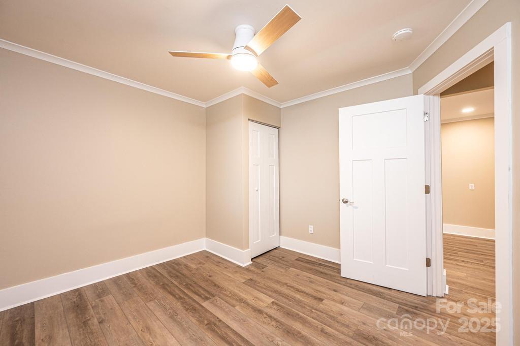 1105 Wildwood Road Lenoir, NC 28645 - Photo 26 of 38 an empty room with wooden floor and a ceiling fan