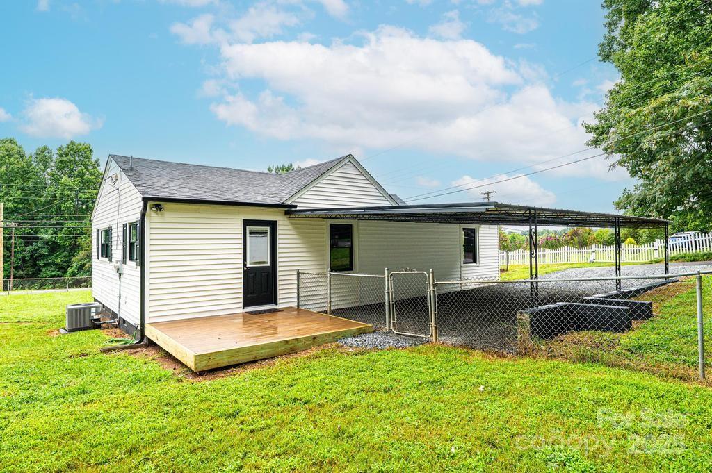1105 Wildwood Road Lenoir, NC 28645 - Photo 30 of 38 a view of a house with a backyard and a patio