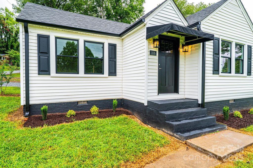1105 Wildwood Road Lenoir, NC 28645 - Photo 3 of 38 a front view of a house with garden