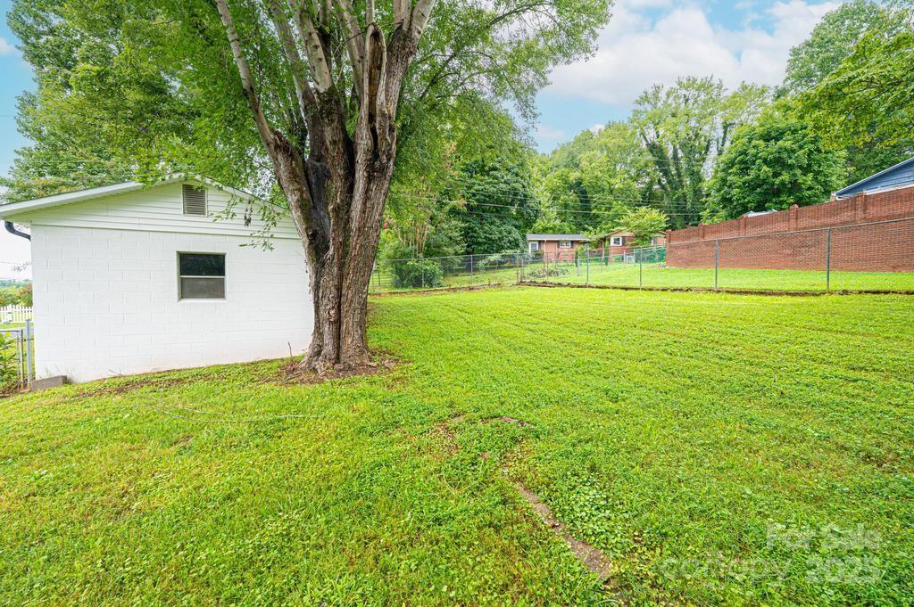 1105 Wildwood Road Lenoir, NC 28645 - Photo 35 of 38 a view of a backyard with a garden