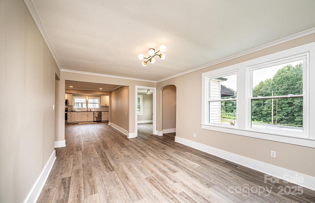 1105 Wildwood Road Lenoir, NC 28645 - Photo 9 of 38 a view of empty room with wooden floor and fan