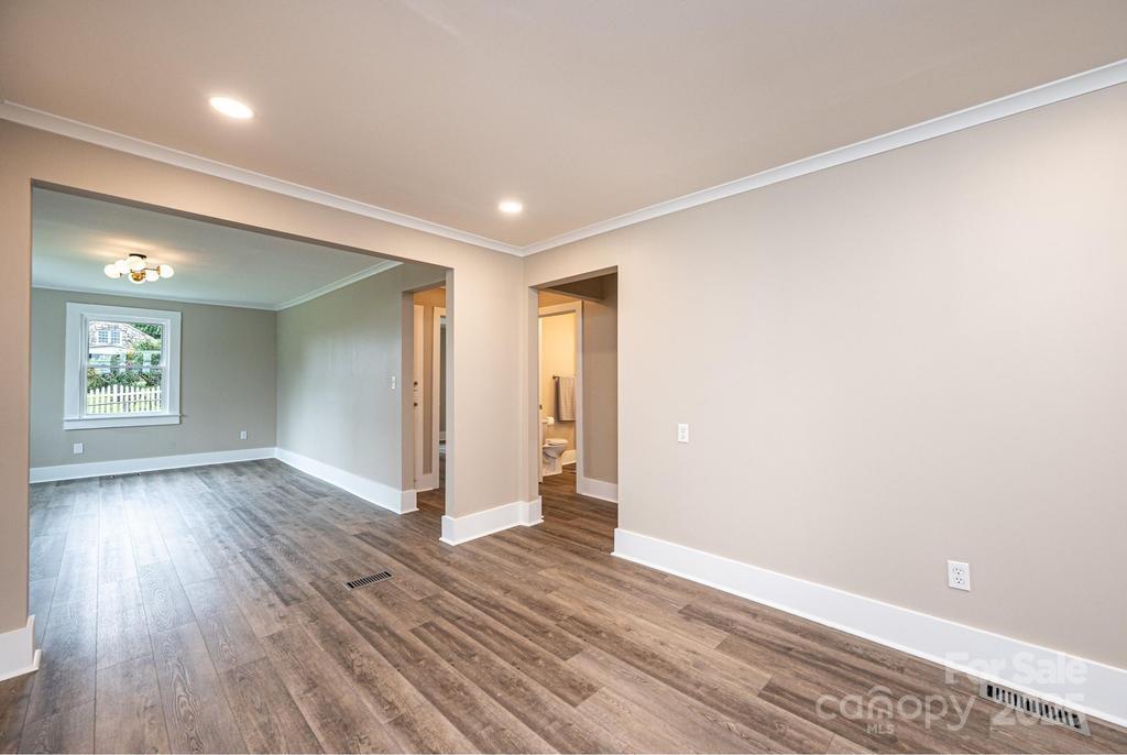 1105 Wildwood Road Lenoir, NC 28645 - Photo 10 of 38 a view of an empty room with wooden floor and a window