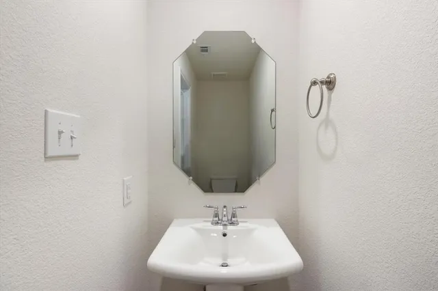 a bathroom with a sink and mirror