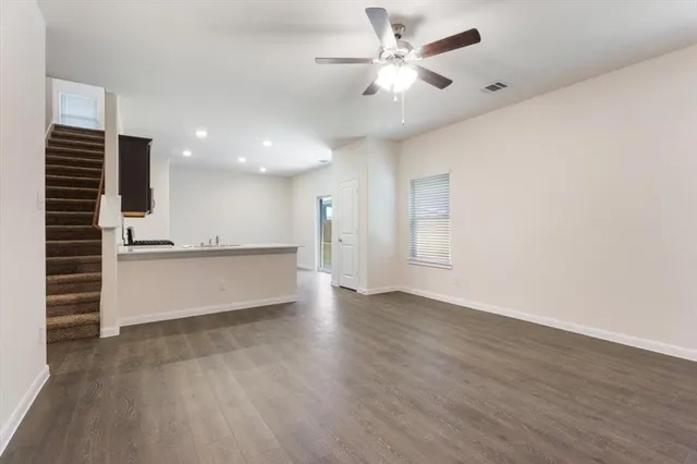 a view of an empty room with a kitchen