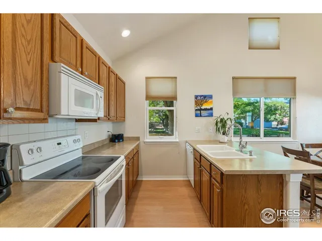 a kitchen that has a sink and a stove in it