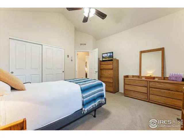 a spacious bedroom with a bed and a dresser