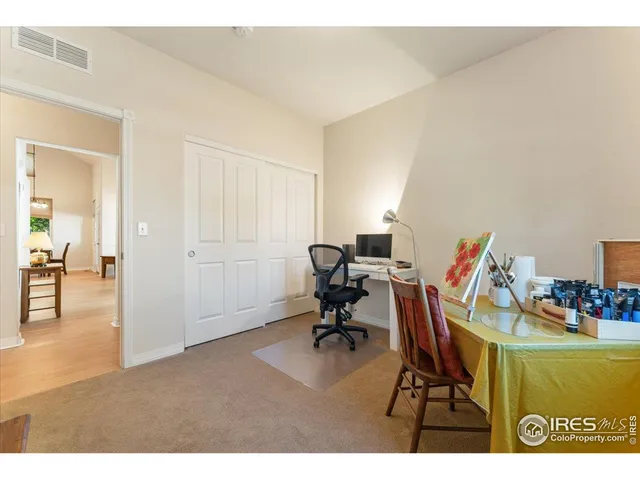 a workspace with furniture and a wooden floor