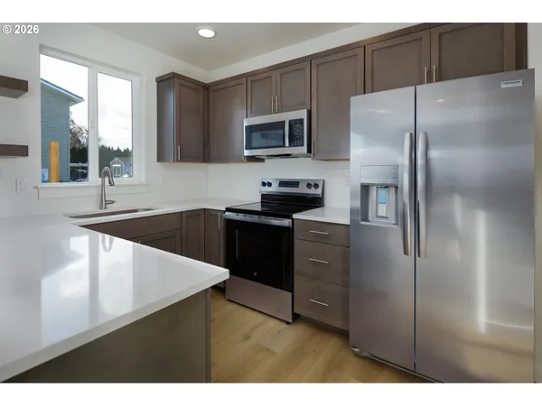 a kitchen with a refrigerator and a sink