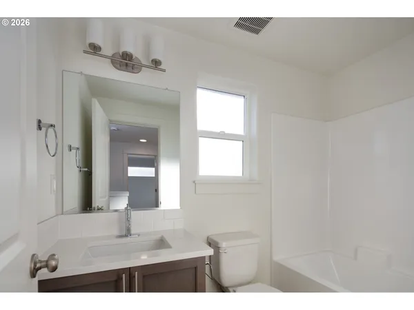 a bathroom with a sink vanity and a mirror