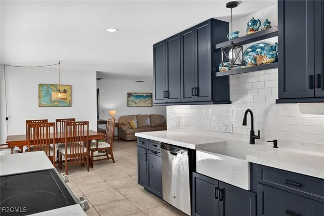 a kitchen with stainless steel appliances granite countertop a sink and a cabinets