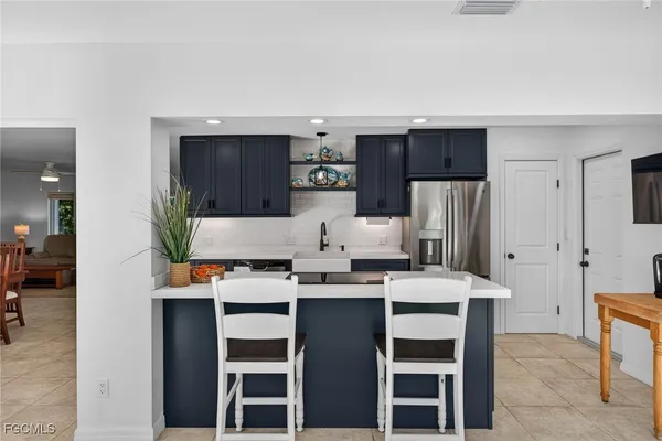 a kitchen with stainless steel appliances a refrigerator and stove