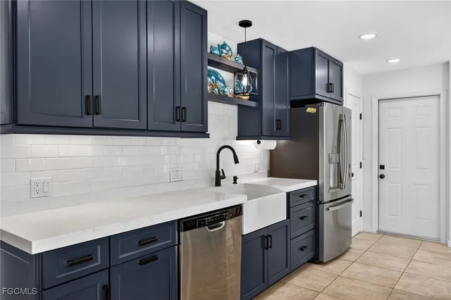 a kitchen with stainless steel appliances granite countertop a refrigerator and a sink