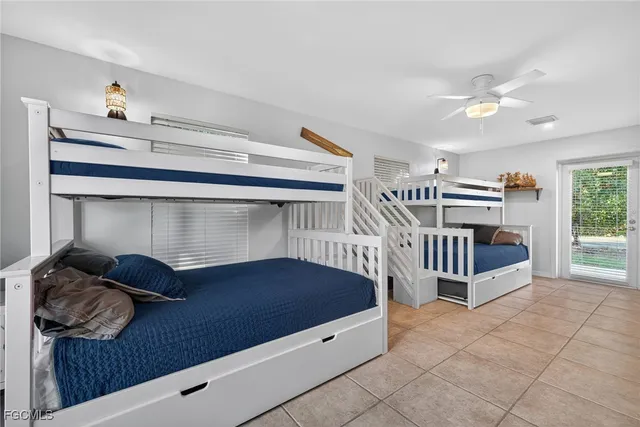 a bedroom with a bed and a large window