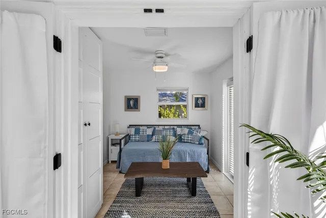 a living room with furniture and a potted plant