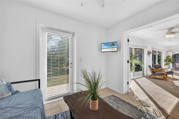 a living room with furniture and a potted plant