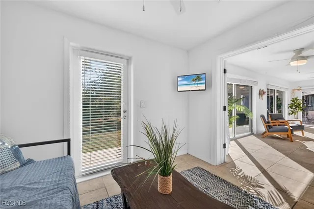 a living room with furniture and a potted plant