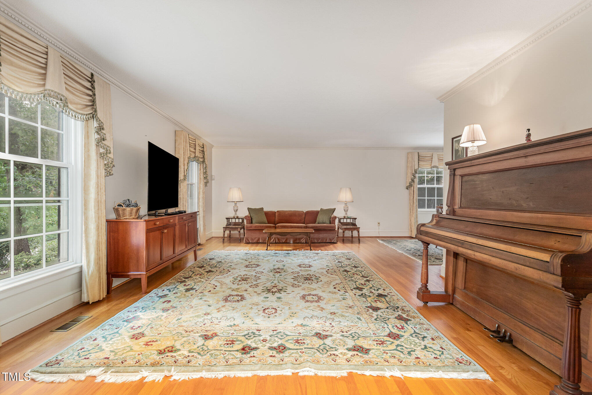 4113 Glen Laurel Drive Raleigh, NC 27612 - Photo 4 of 23 a living room with furniture and a flat screen tv
