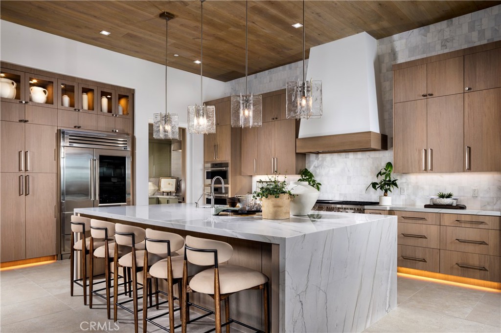 564 Peninsula Irvine, CA 92602 - Photo 12 of 20 a kitchen with stainless steel appliances a sink stove and refrigerator