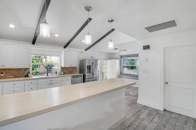 a bathroom with a granite countertop sink a toilet and a mirror