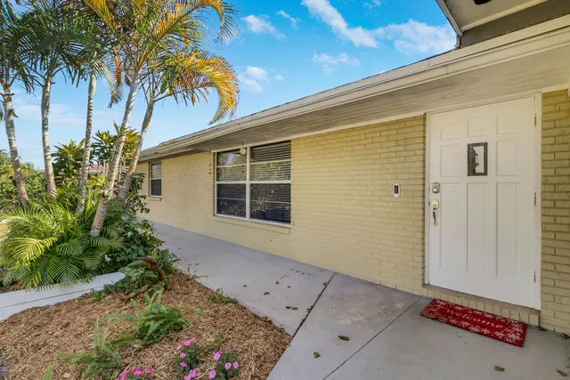 a living room with furniture flat screen tv and wooden floor