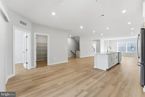 a living room with furniture and a painting on the wall