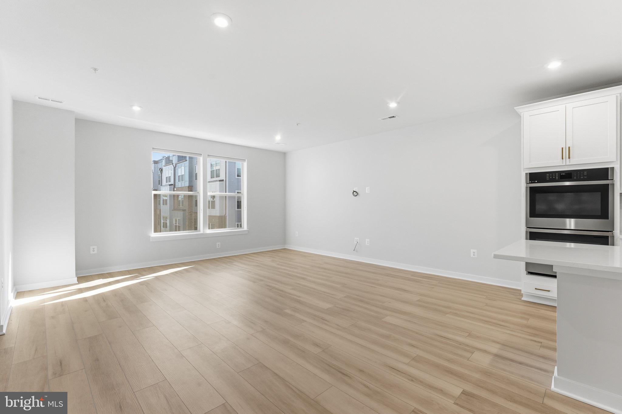 2136 Glacier Road Herndon, VA 20170 - Photo 16 of 79 a view of empty room with wooden floor and window