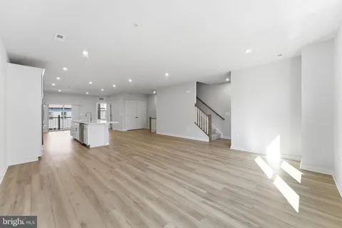an empty room with an entryway and closet area