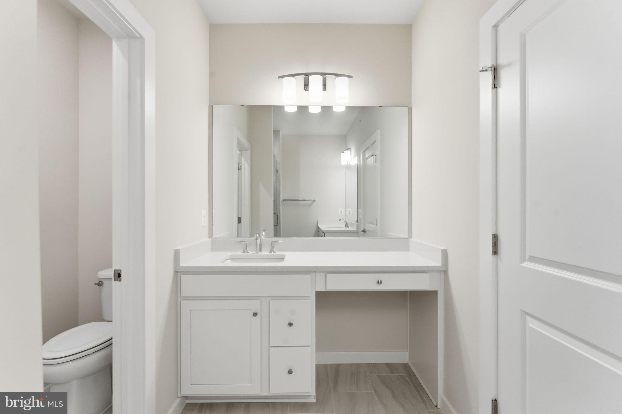2136 Glacier Road Herndon, VA 20170 - Photo 29 of 79 a bathroom with a granite countertop sink a toilet and a mirror