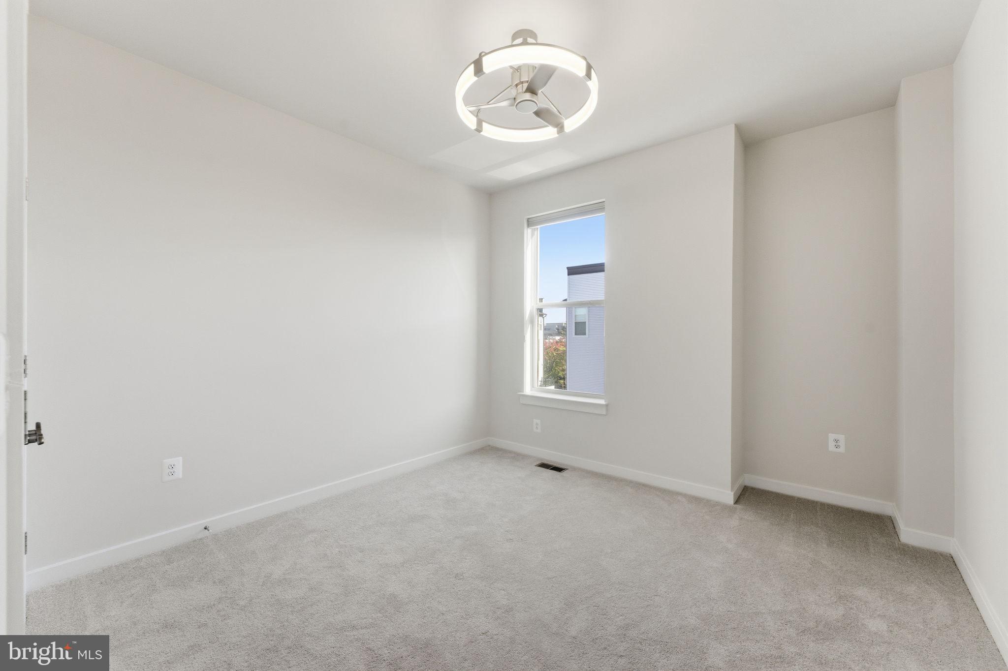 2136 Glacier Road Herndon, VA 20170 - Photo 33 of 79 an empty room with a chandelier fan and windows