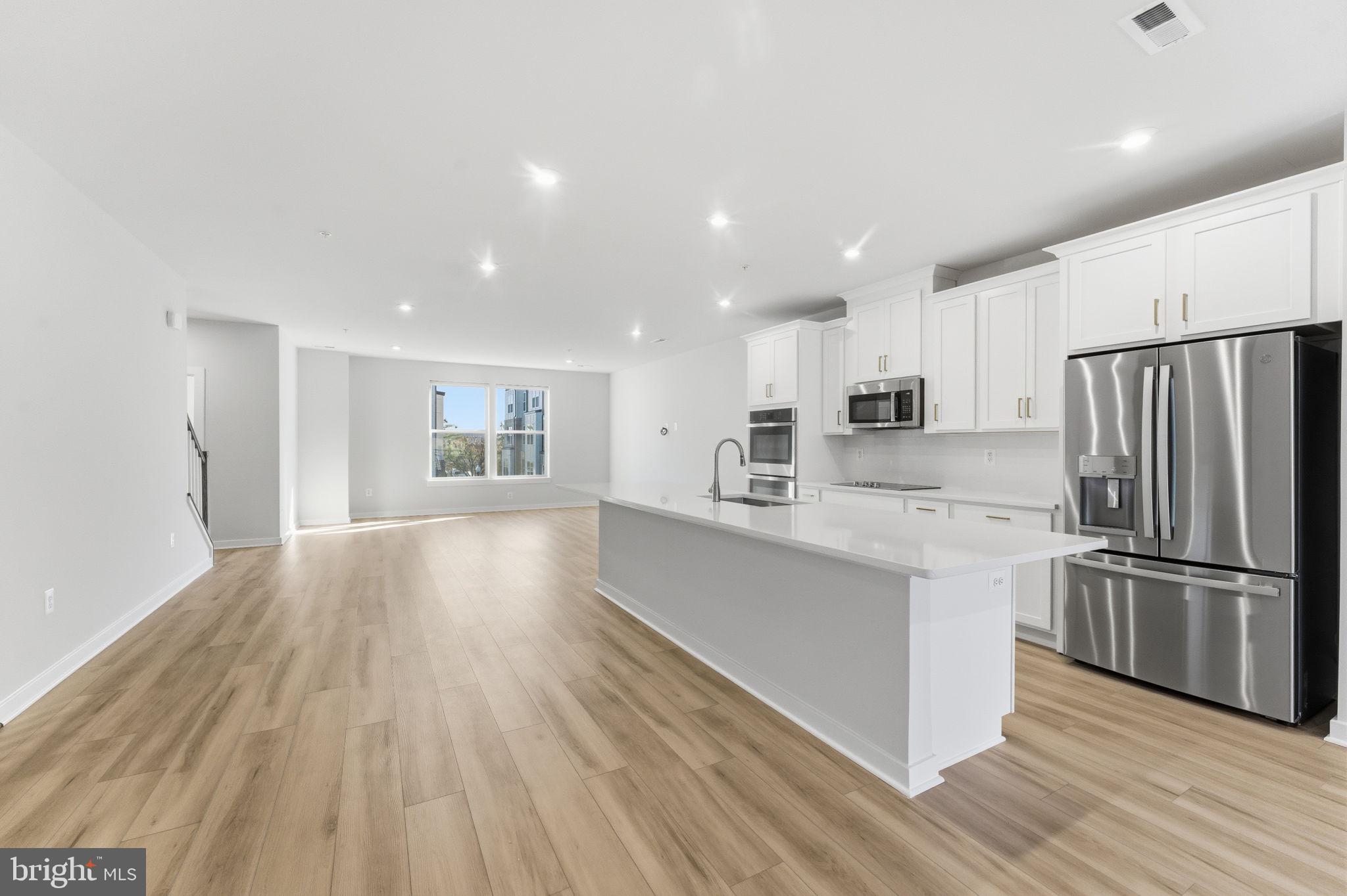 2136 Glacier Road Herndon, VA 20170 - Photo 4 of 79 a kitchen with stainless steel appliances granite countertop a refrigerator and a stove top oven