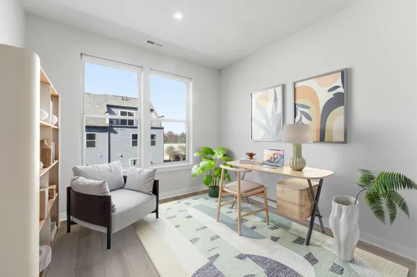 a living room with furniture and a painting on the wall