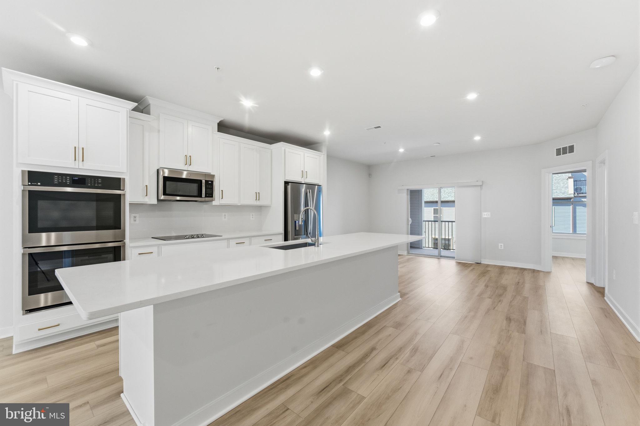 2136 Glacier Road Herndon, VA 20170 - Photo 9 of 79 a large kitchen with a large counter top appliances and cabinets