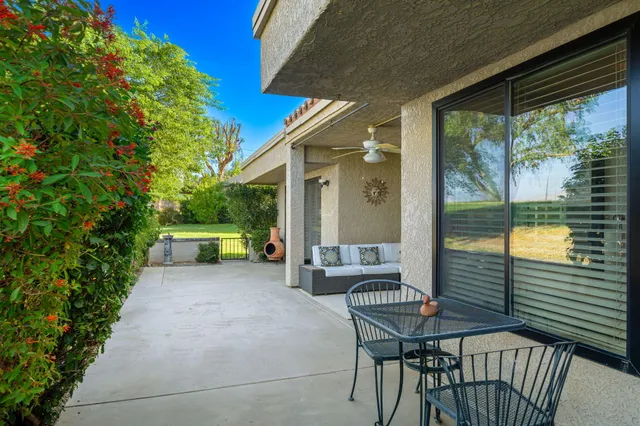 a view of a chairs and table in the balcony