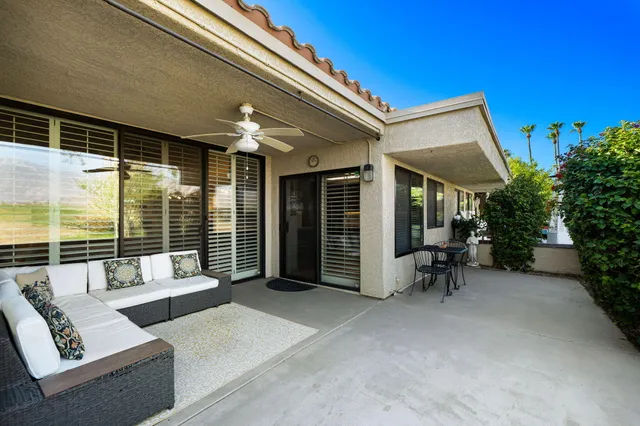 a balcony with furniture and a potted plant