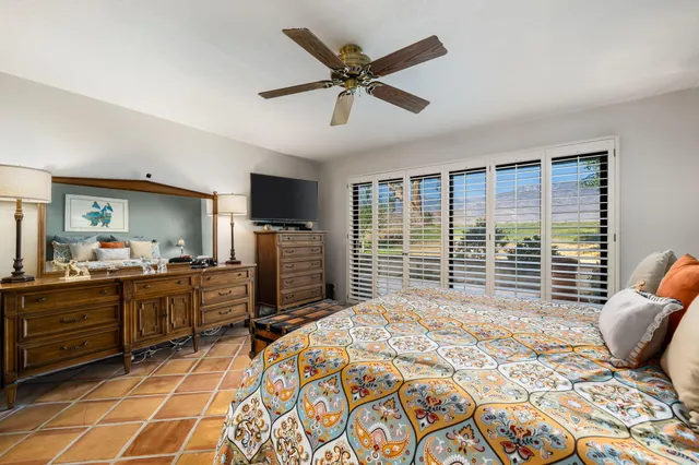 a bedroom with a bed and a television