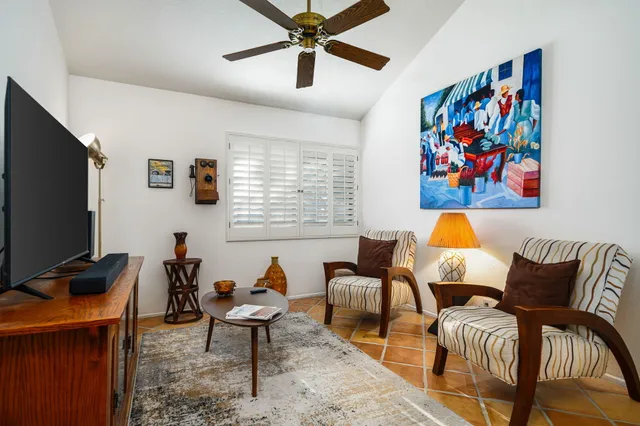 a living room with furniture a couch and a flat screen tv