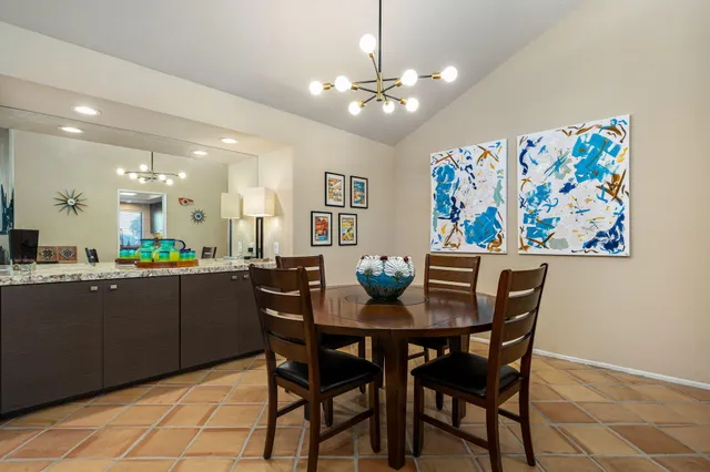 a view of a dining room with furniture and chandelier