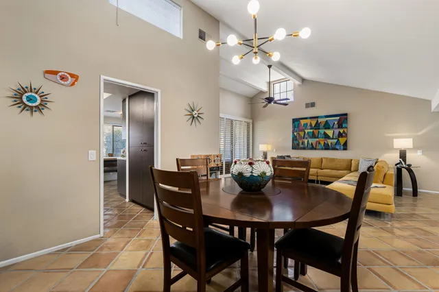 a view of a dining room with furniture and chandelier