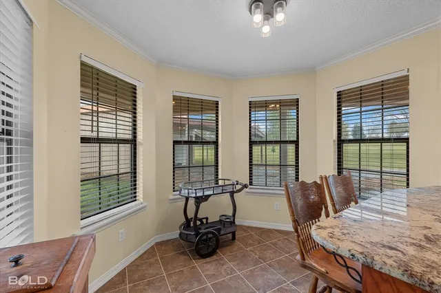 a living room with furniture and floor to ceiling windows