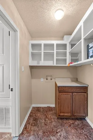 a room with a fireplace and cabinets