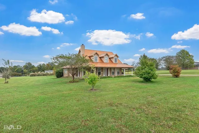 a view of a big house with a big yard