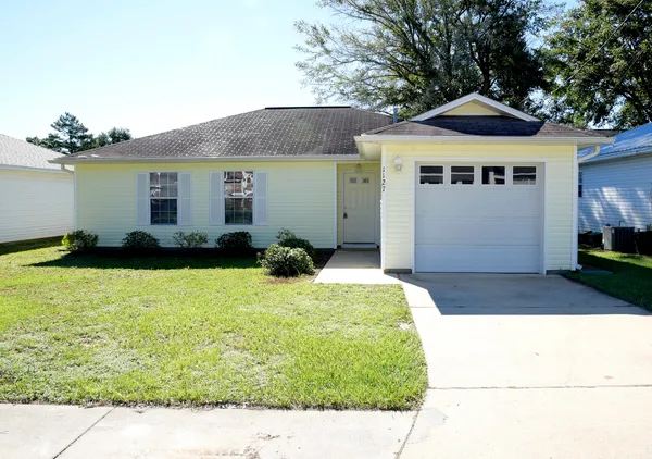 a front view of a house with a yard